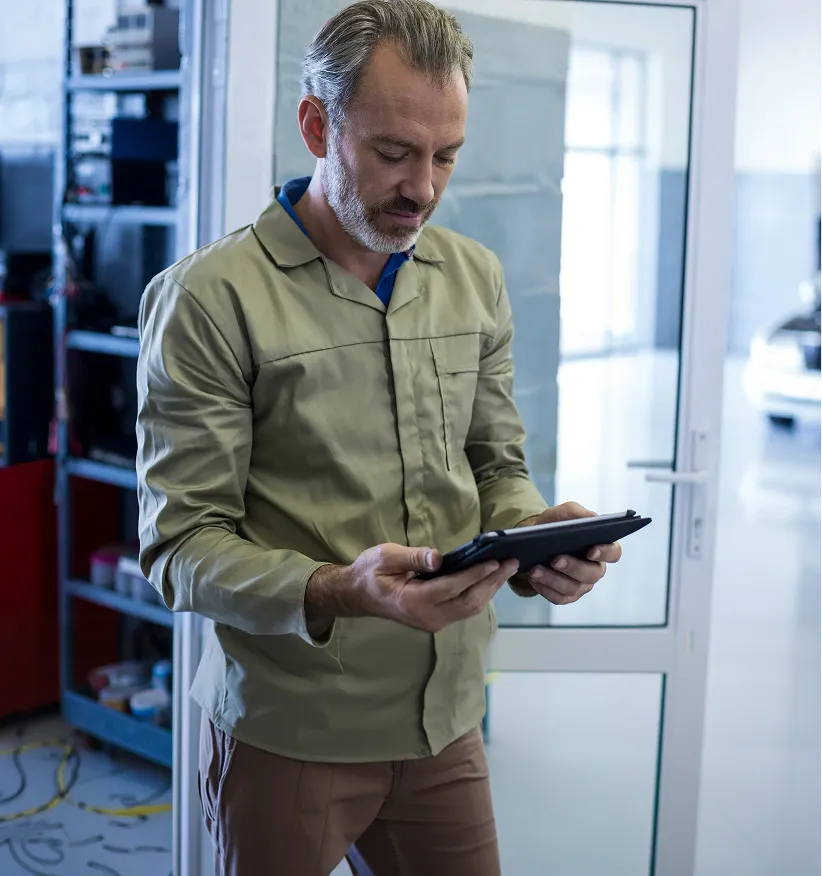 Fleet worker reviewing details on a tablet in a workshop