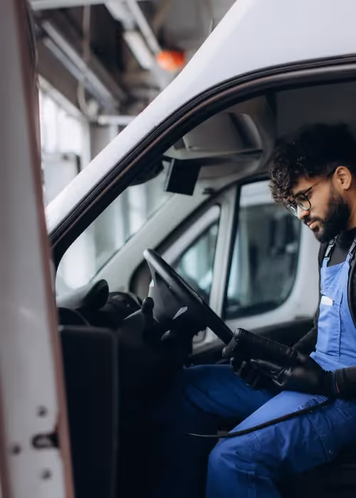 man inside van on tablet