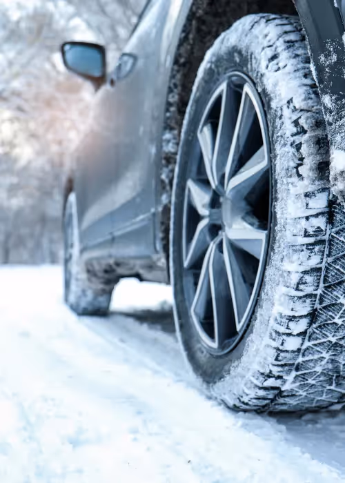 White van driving on a snowy road