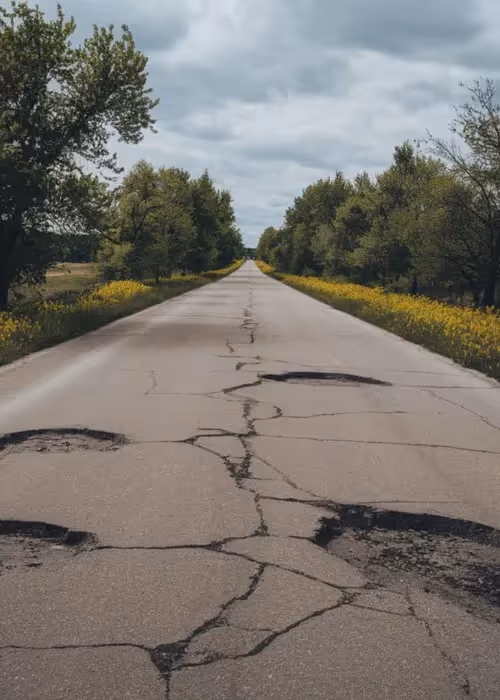 image of a road with a pothole in it