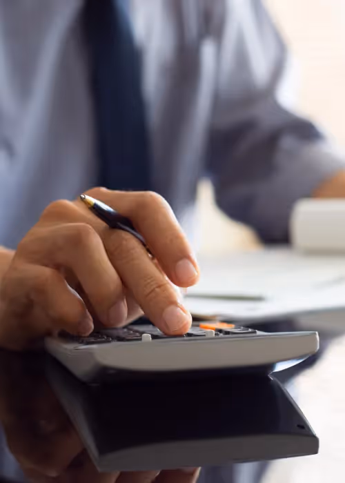 Person looking at receipts and a calculator