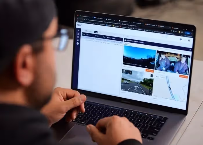 Man sitting in front of a laptop looking at the Ram app