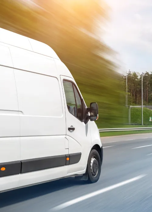 Person driving in a van on the road