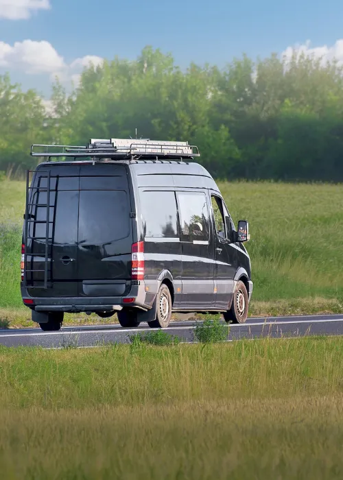 Person driving in a van on the road