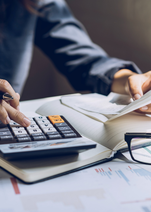Person looking at expenses and using a calculator