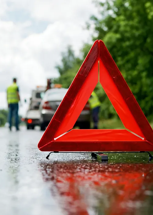 Breakdown triangle in front of a car on the side of the road