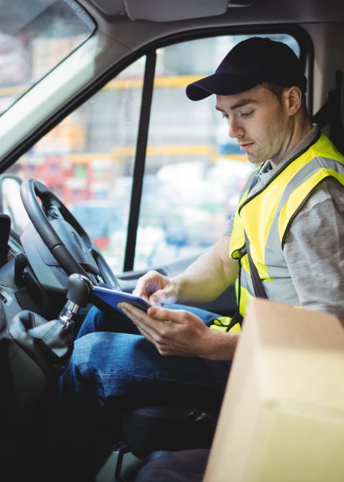 Man sat in van using tablet