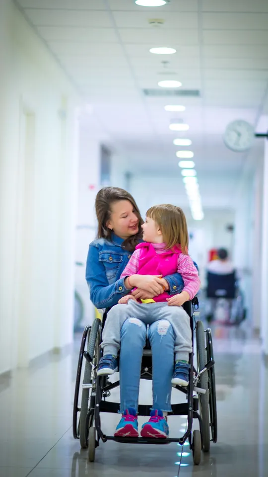 A mother and her daughter in a hospital corridor