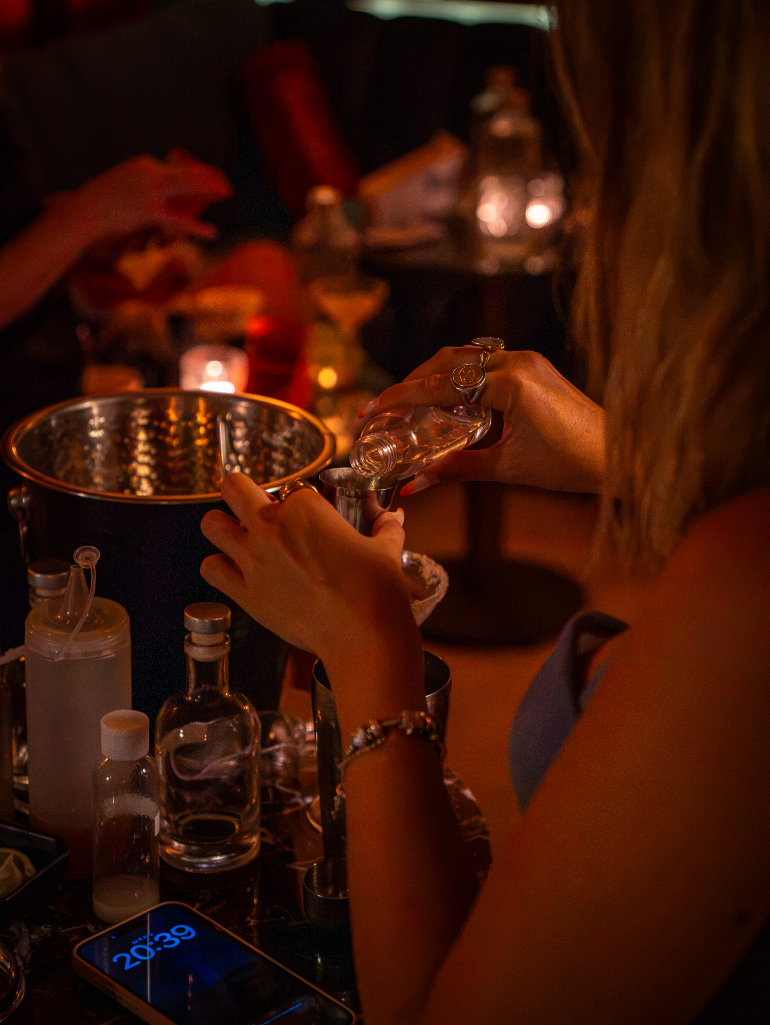 Guest measuring a spirit with a jigger during a cocktail workshop at Sous Sol