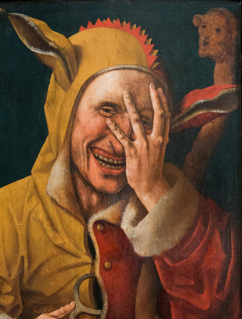 Laughing Fool, Netherlandish painting, c. 1500: a jester in a yellow and green hood with donkey's ears, grinning through his spread fingers