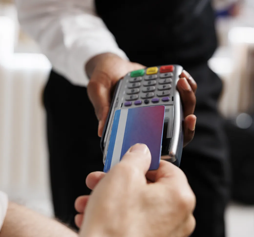 Hand holding a card payment terminal