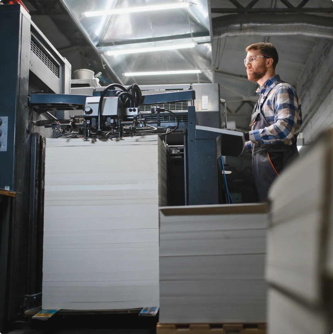 Worker by a printing press