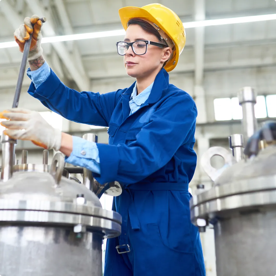 Woman operating a valve in a plant