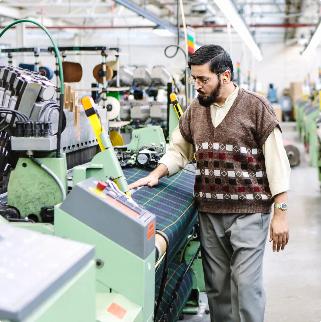 Worker operating a textile machine
