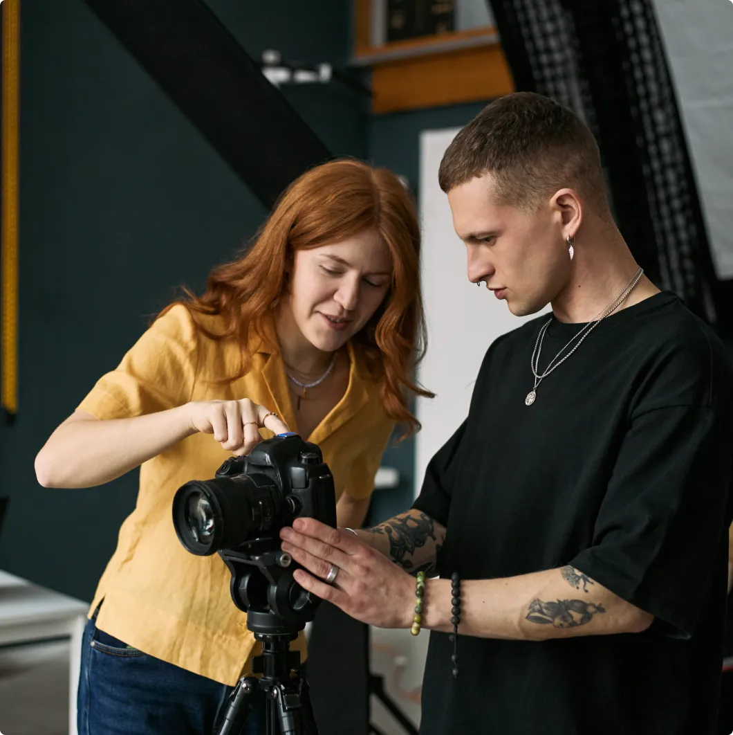Two people reviewing a photo on a camera