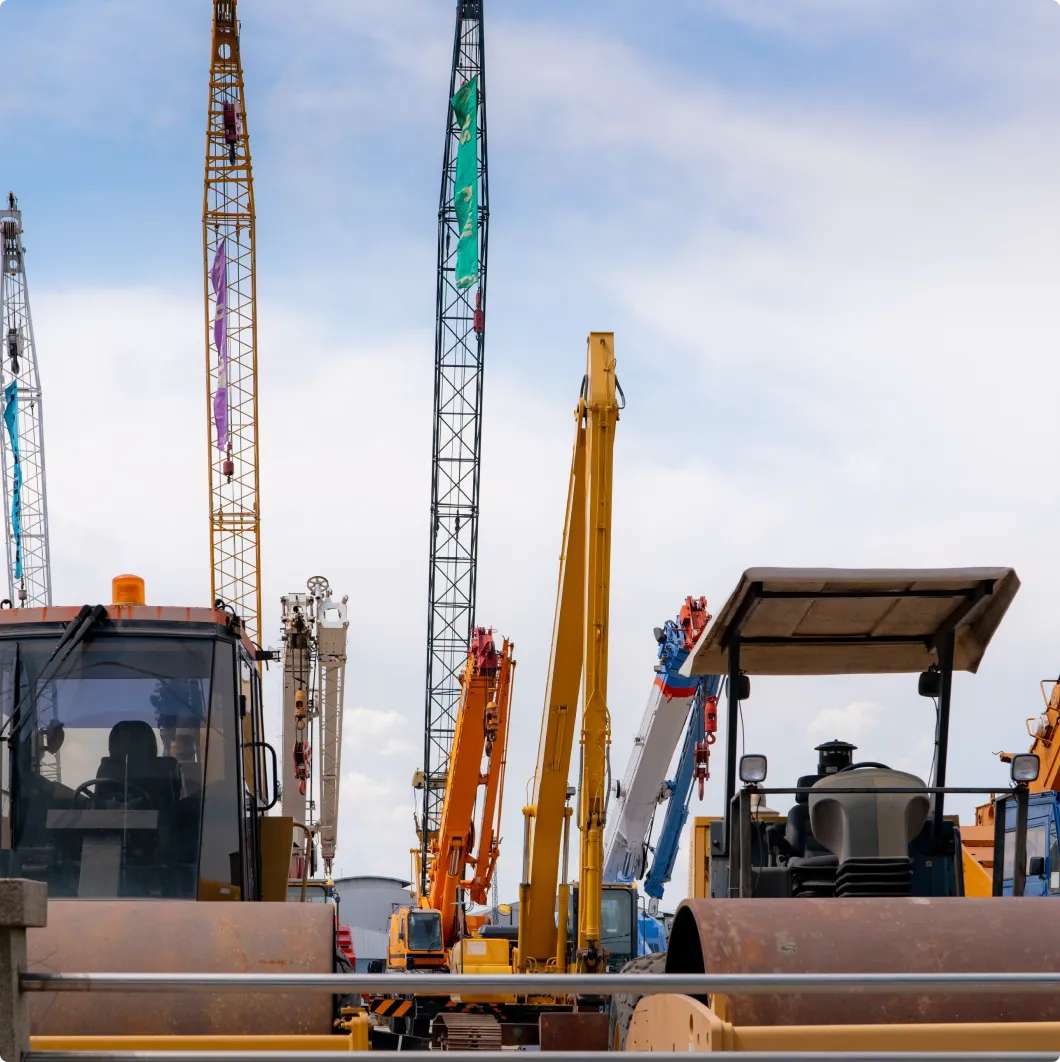 Cranes and heavy machinery at a plant hire yard
