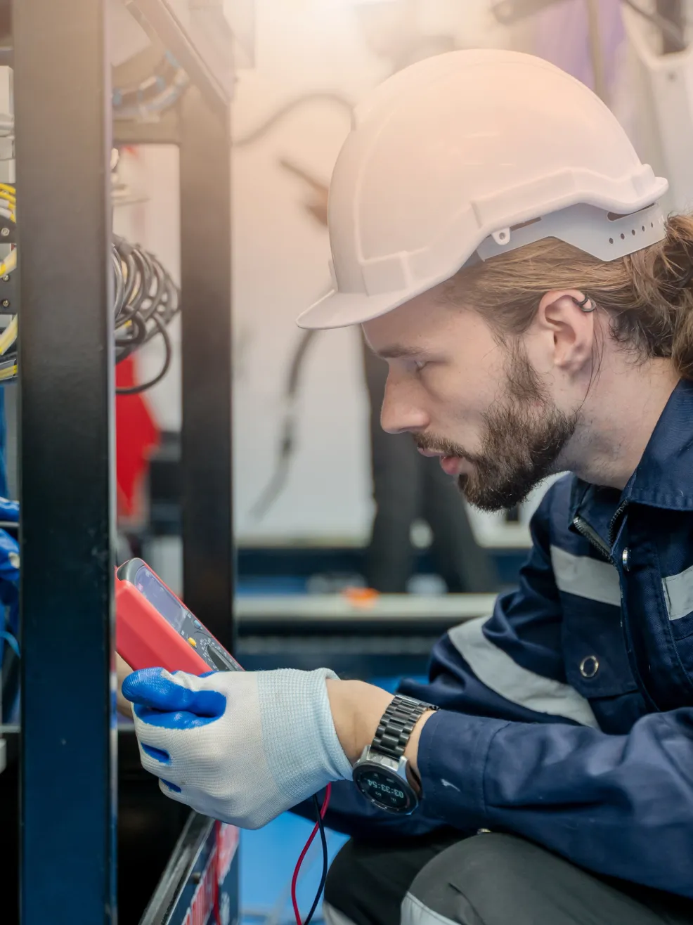 Worker with tools by machinery