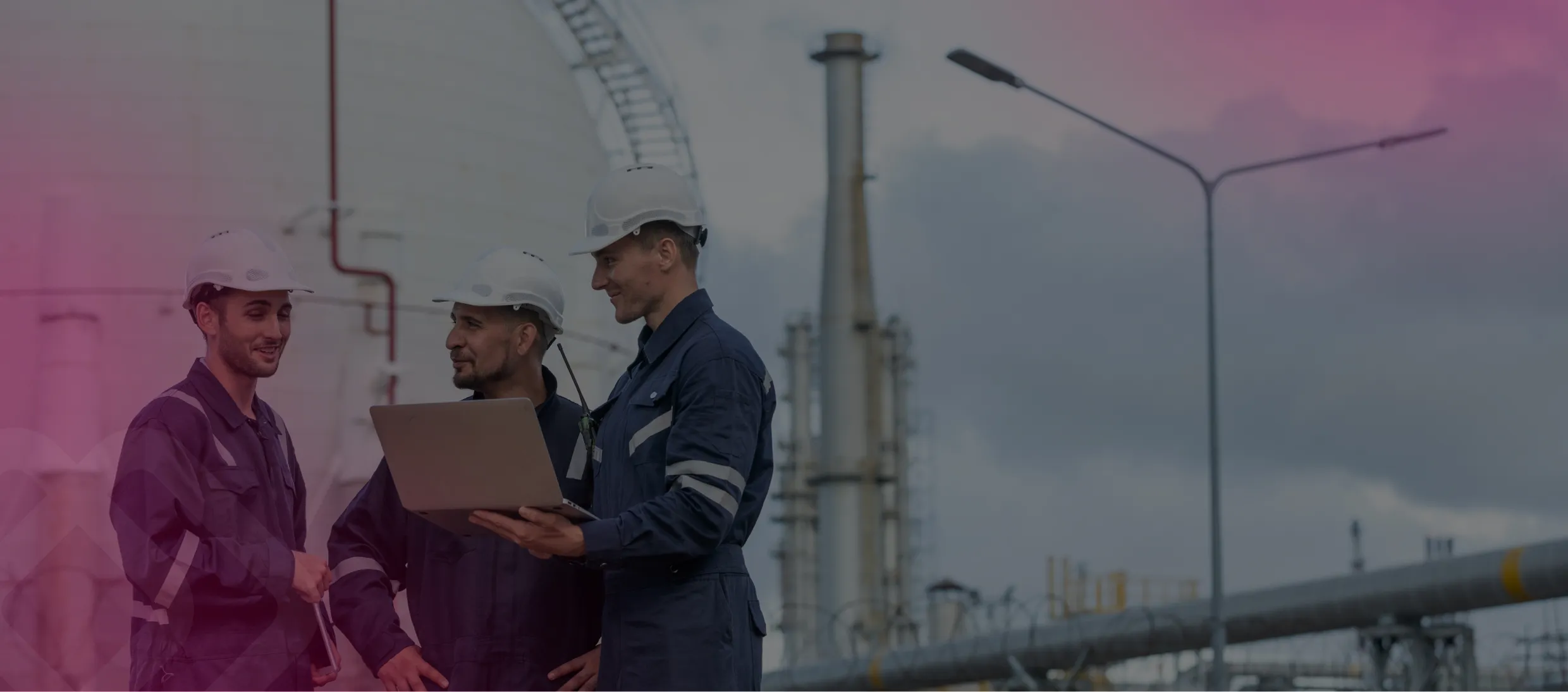 Workers with a laptop at an industrial plant