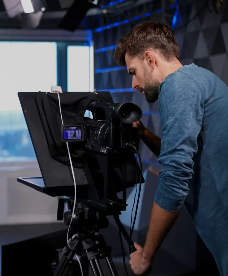 Camera operator with a studio camera and teleprompter