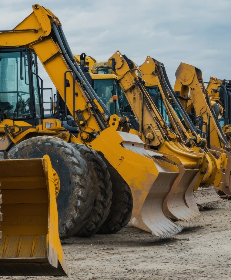 Row of yellow excavators lined up