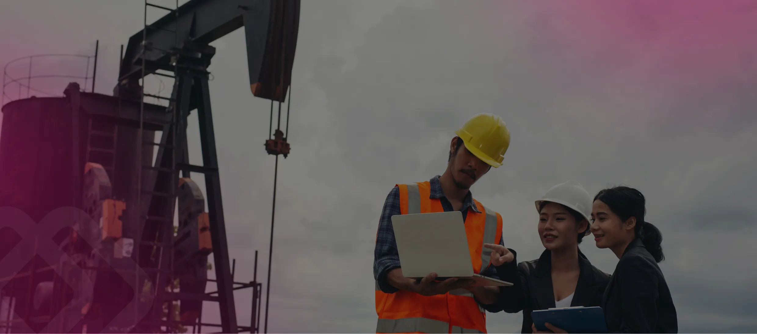 Workers with a laptop by an oil pump