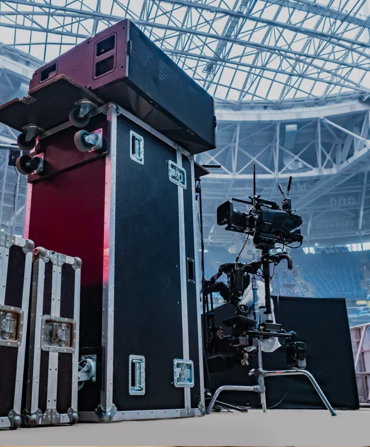 Flight cases and camera equipment in a stadium