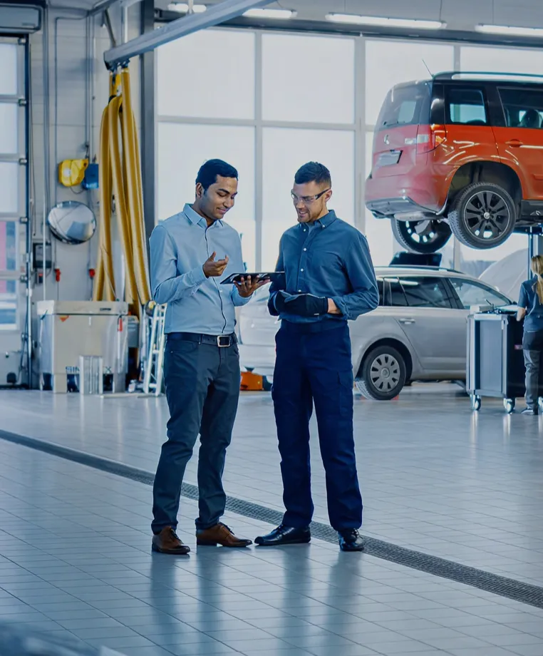 Two colleagues in a car service centre