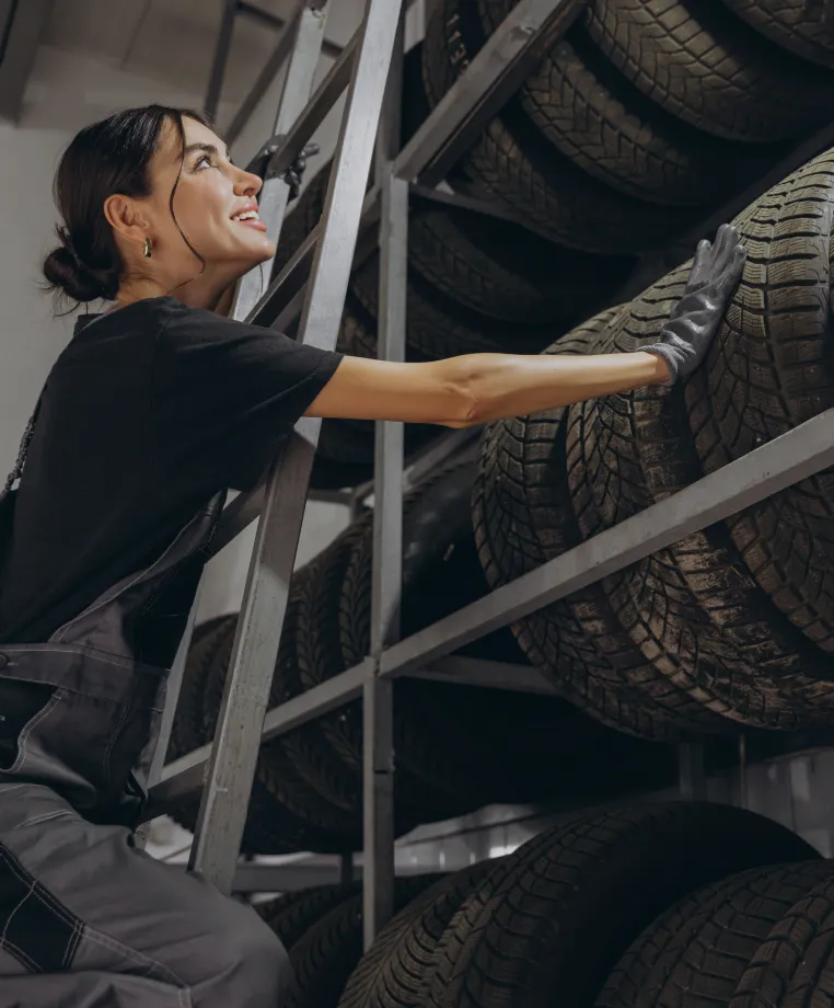 Woman selecting a tyre from a rack