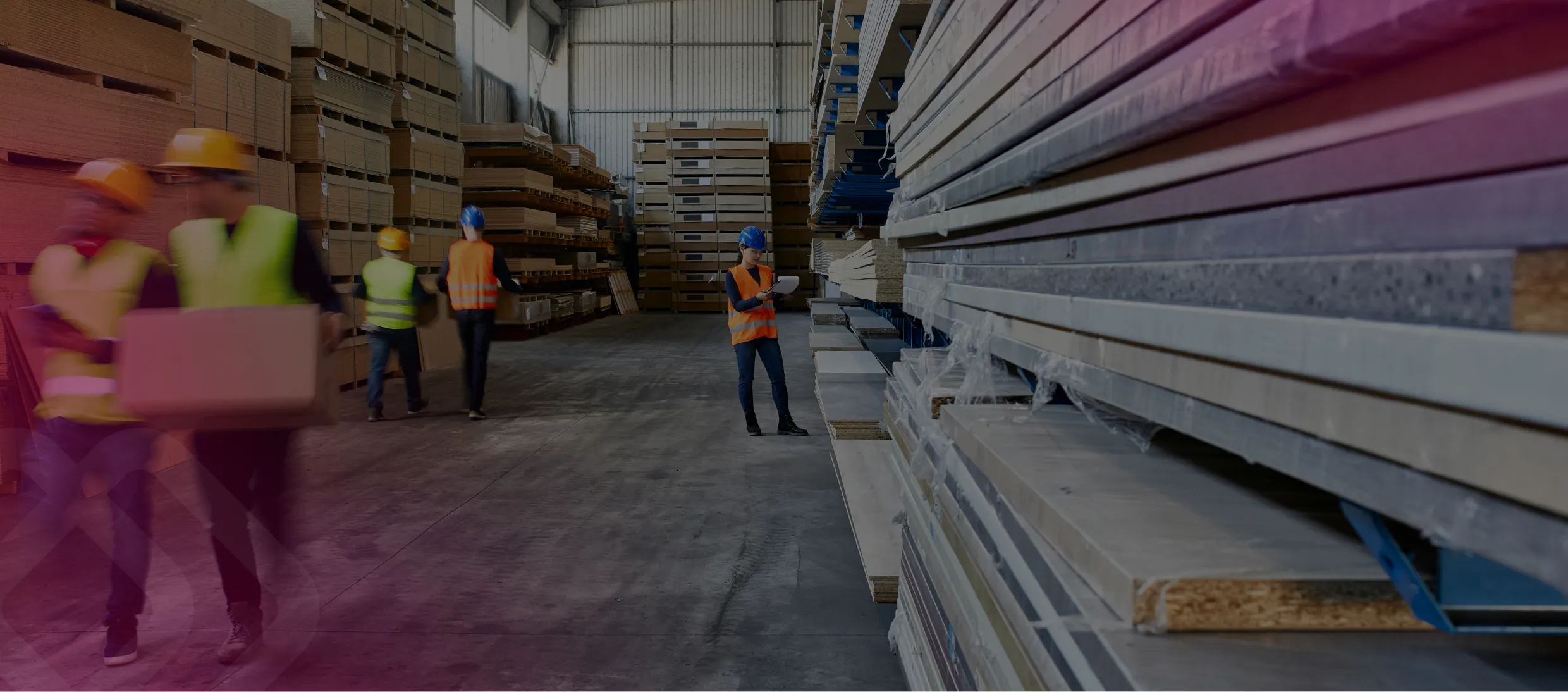 Workers moving materials in a builders' yard