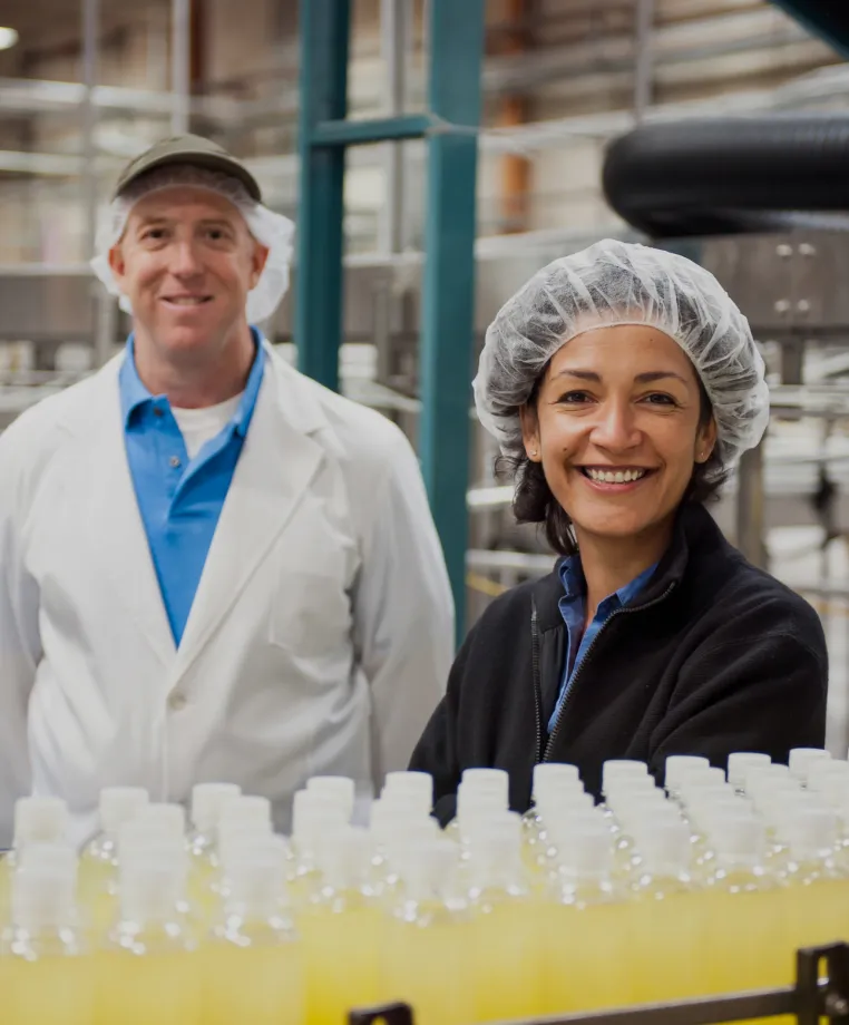 Two workers in a bottling plant