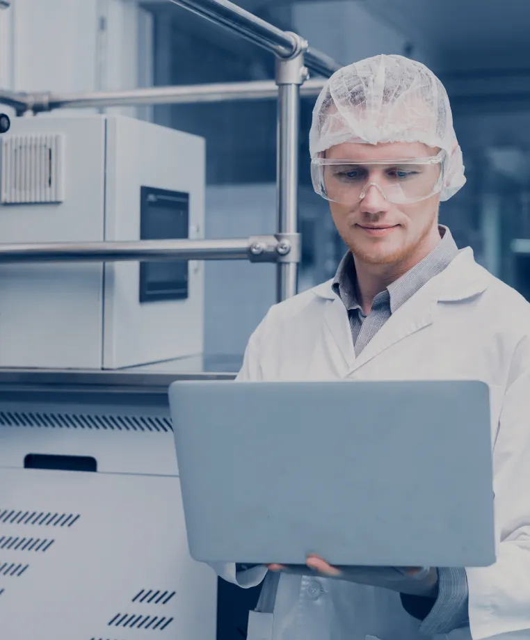 Technician using a laptop in a cleanroom