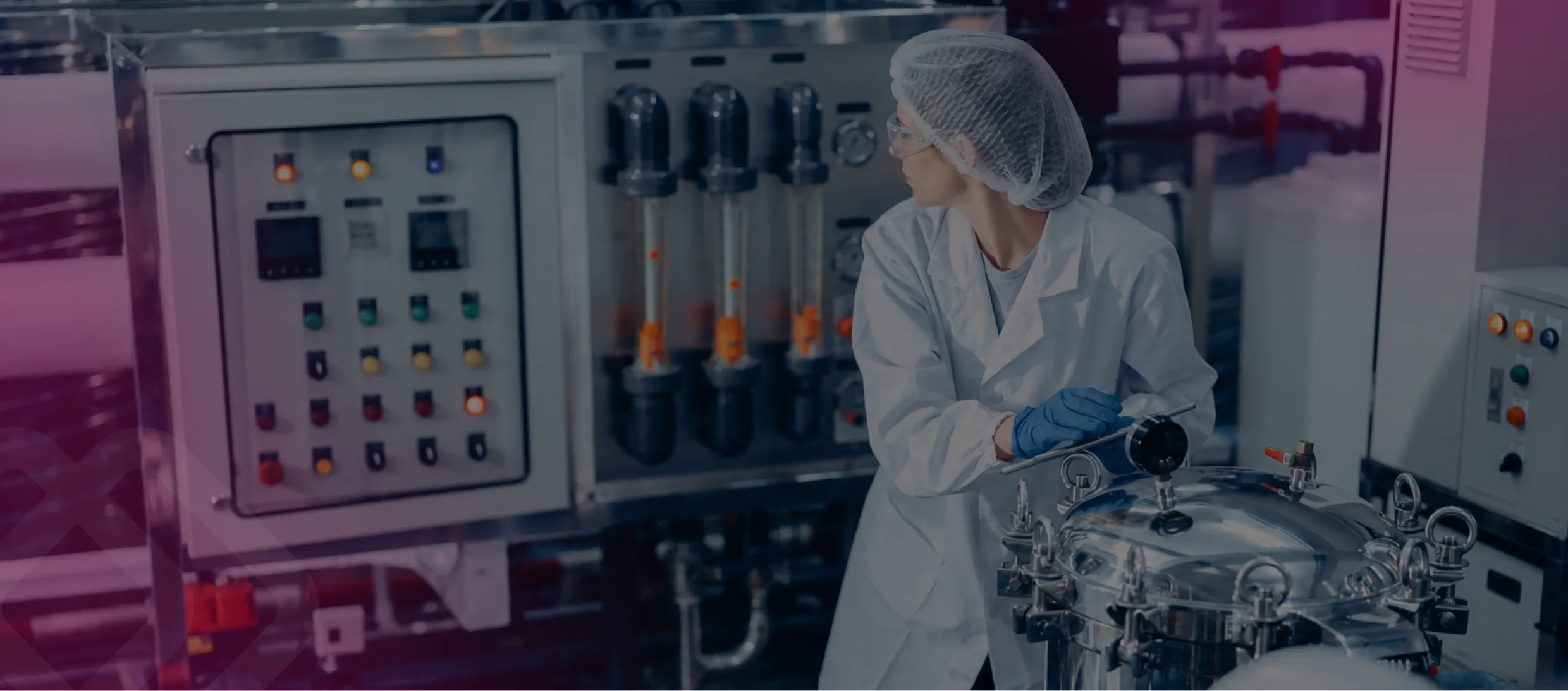 Lab worker by machinery in a plant