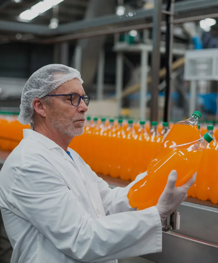 Worker inspecting a bottling production line