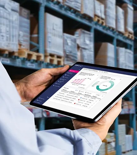 Hands holding a tablet showing a dashboard