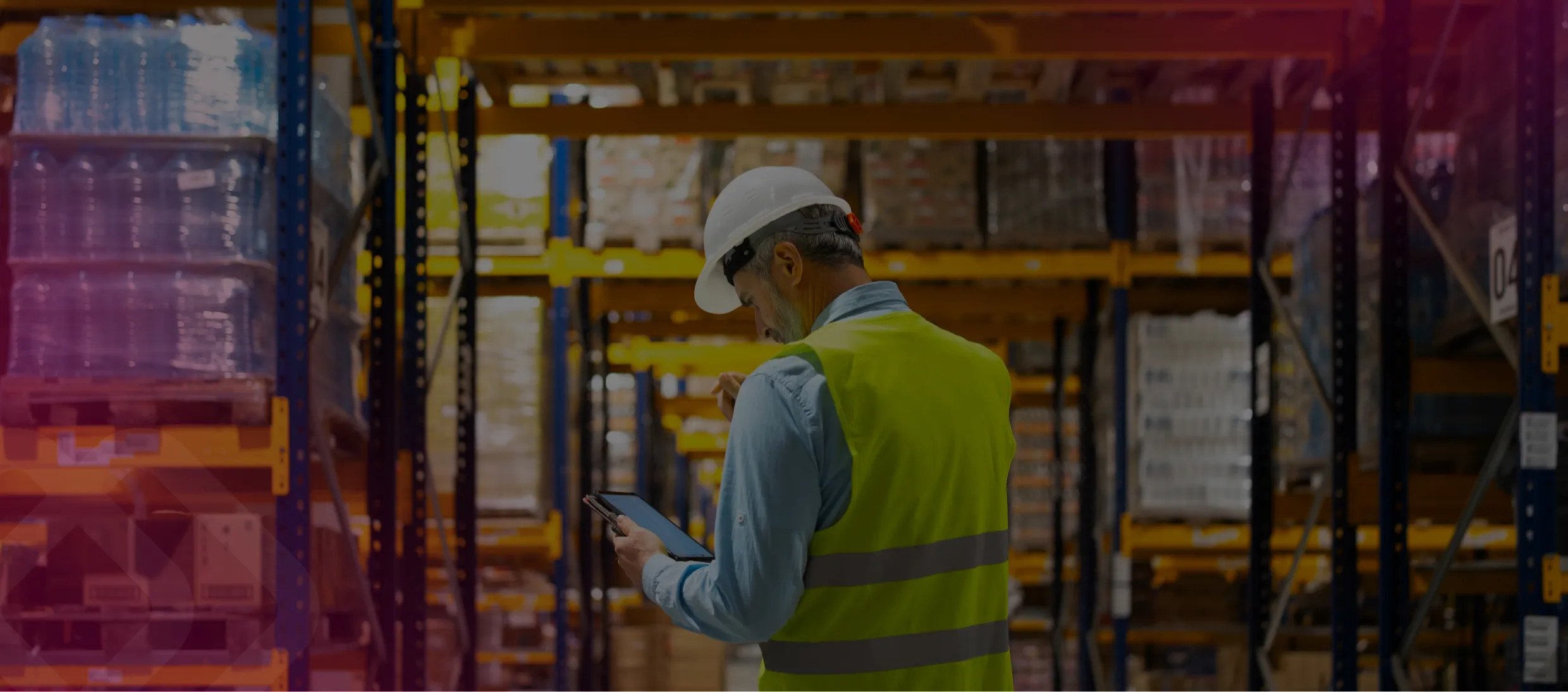 Worker in hi-vis in a warehouse aisle