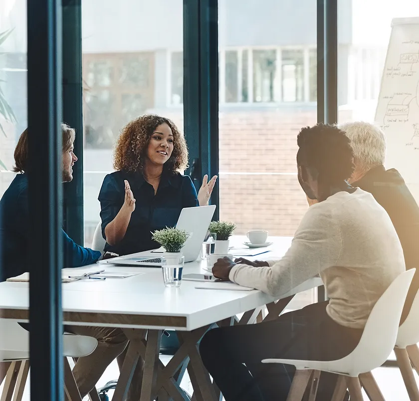 Team meeting around a table by a window