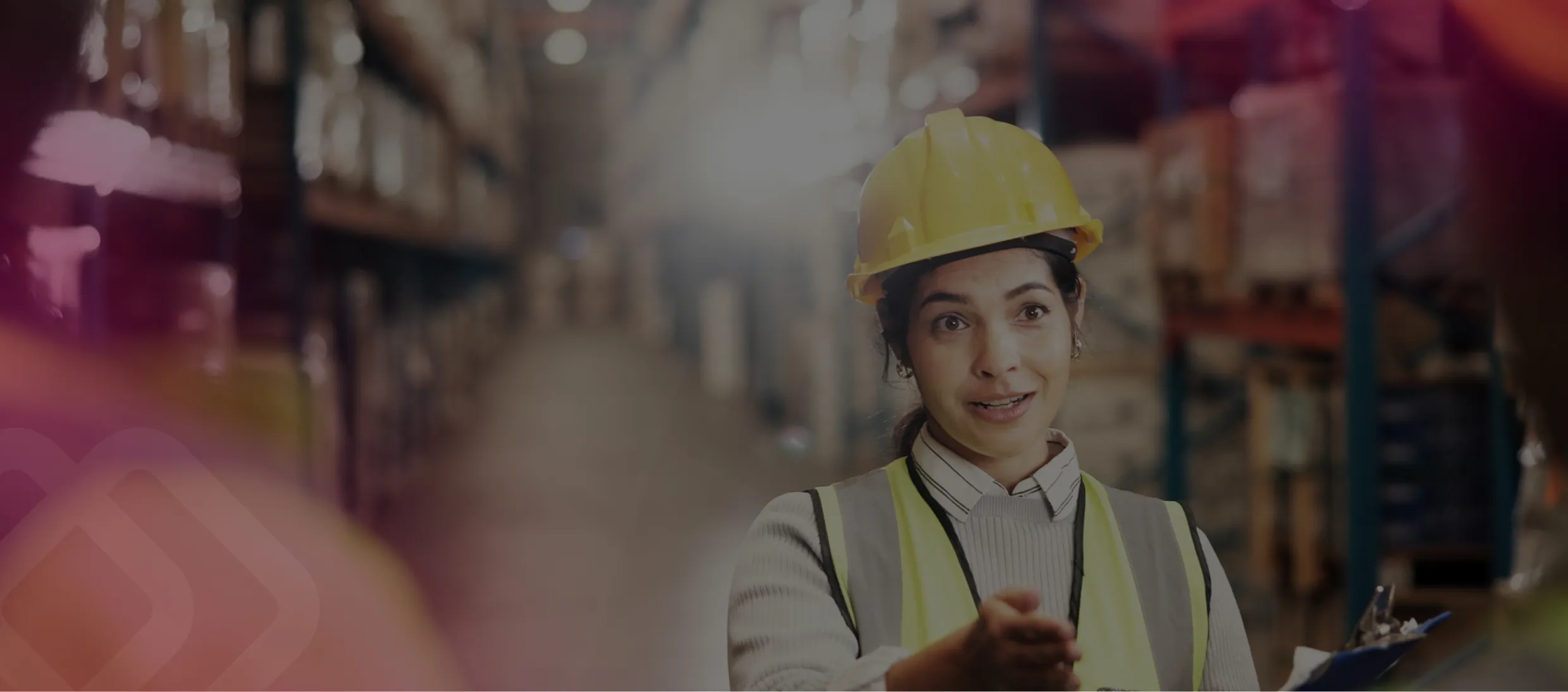 Woman in a hard hat in a warehouse