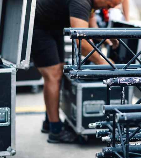 Crew assembling stage truss and rigging
