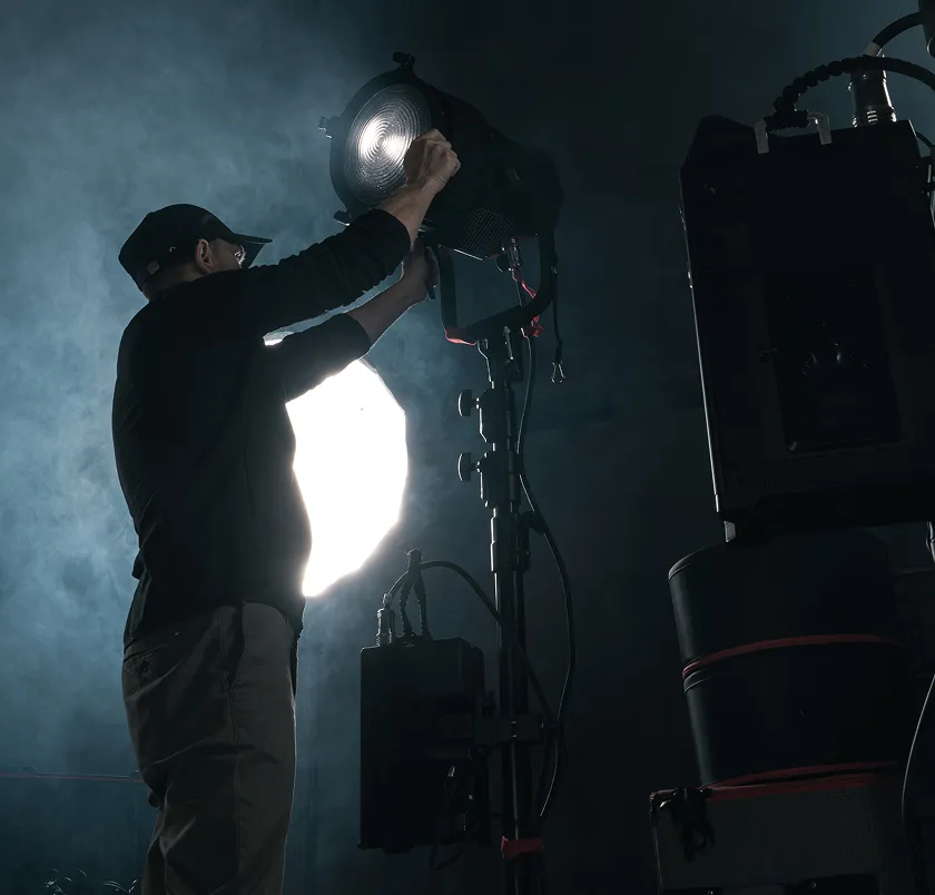 Technician adjusting a stage light