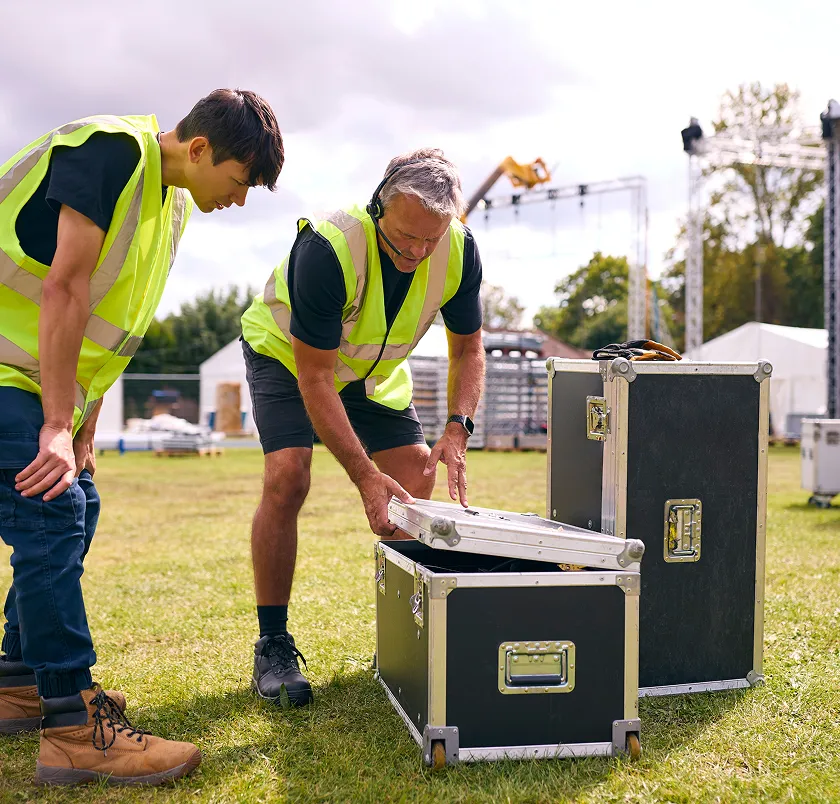 Event crew packing a flight case outdoors