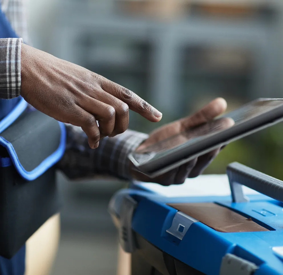 Hand using a tablet mounted on a machine