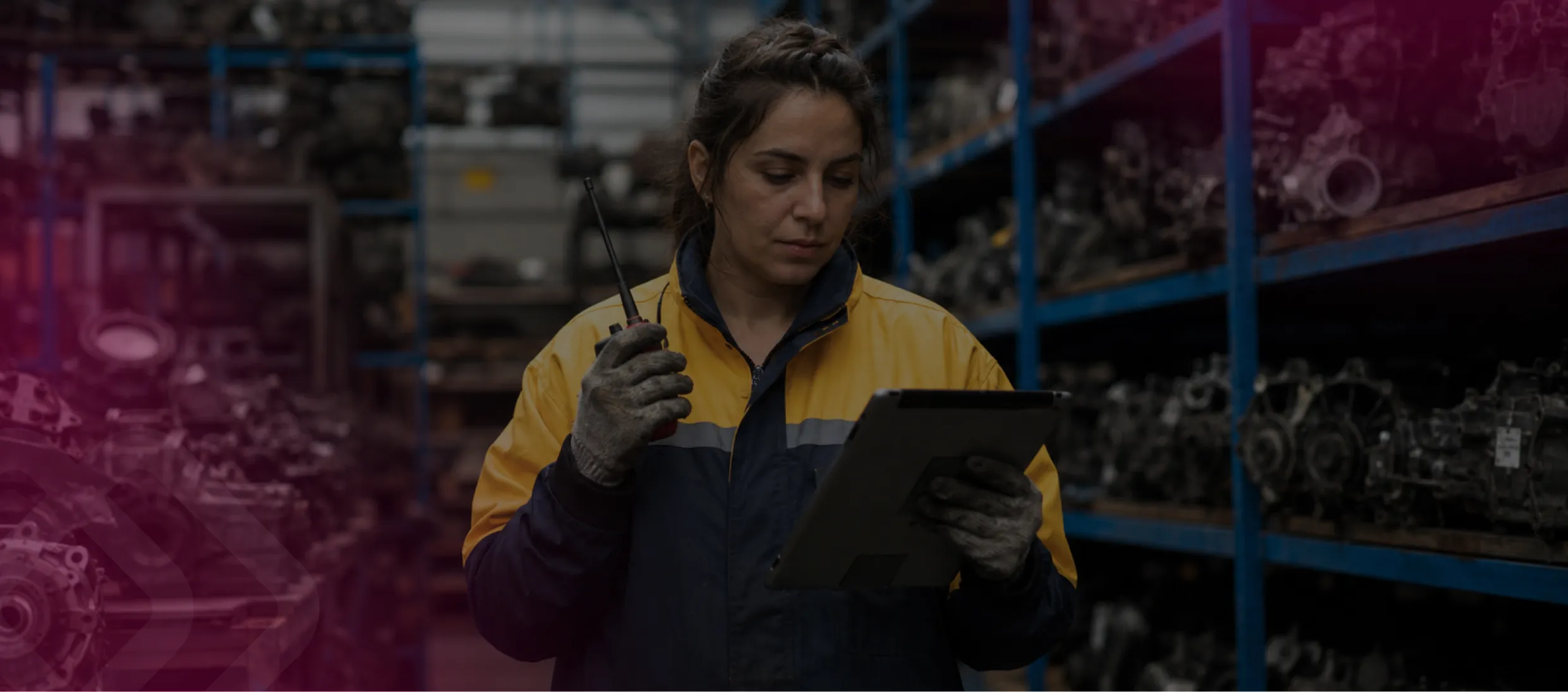 Woman using a tablet in a parts warehouse