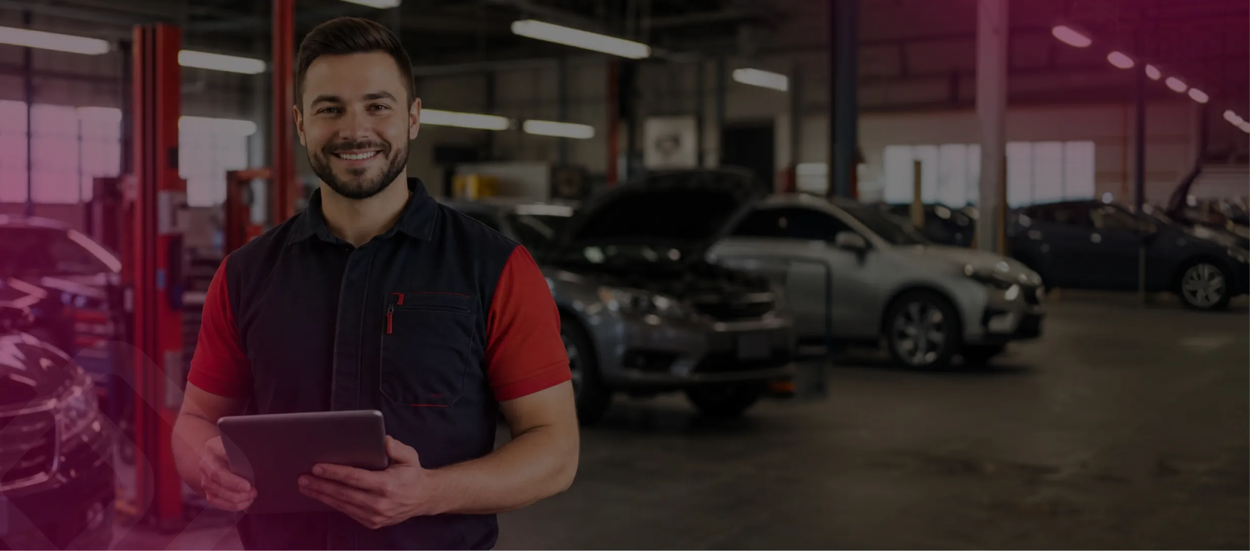 Worker with a tablet by a car