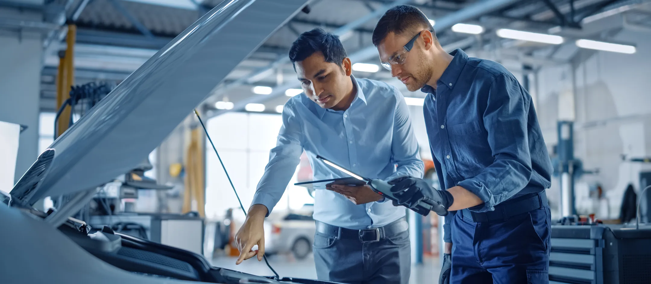 Two technicians inspecting a car windscreen