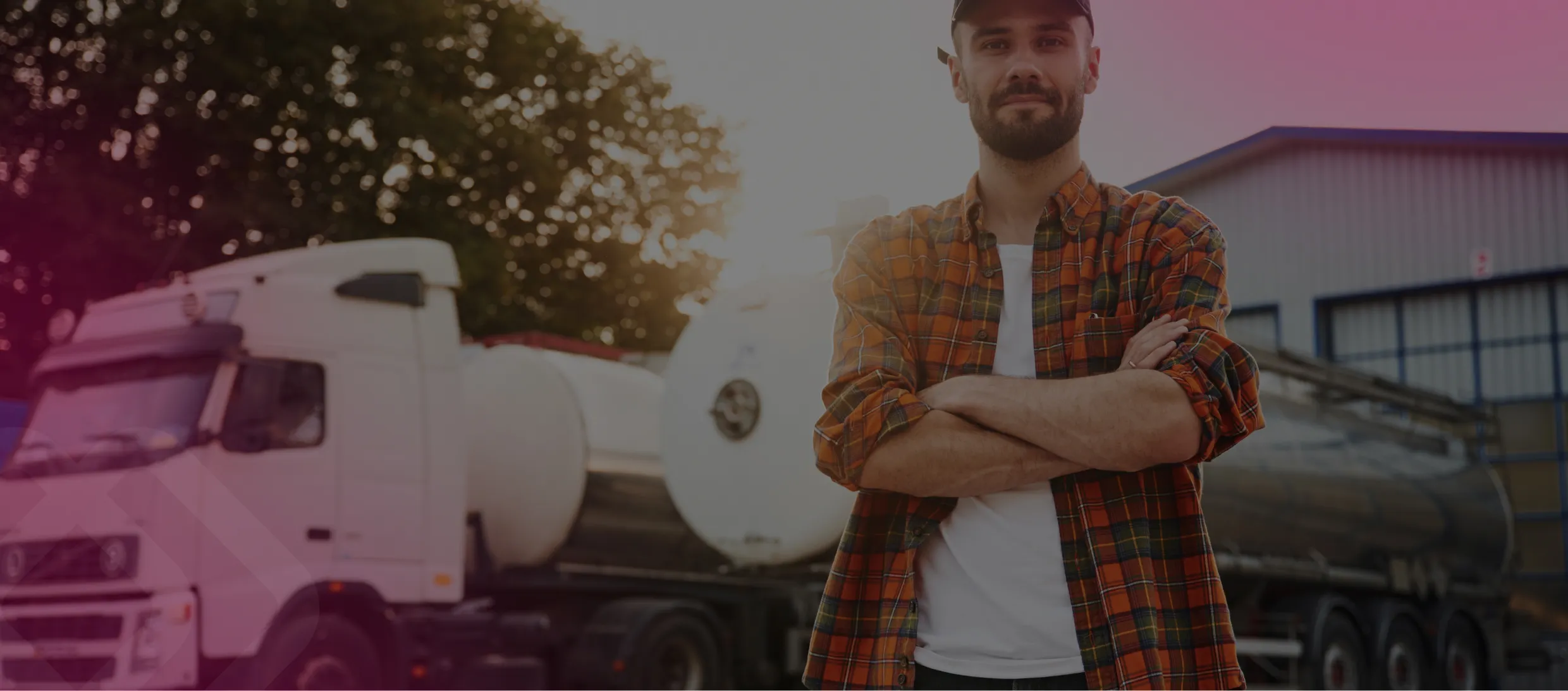 Man by a truck outside a depot