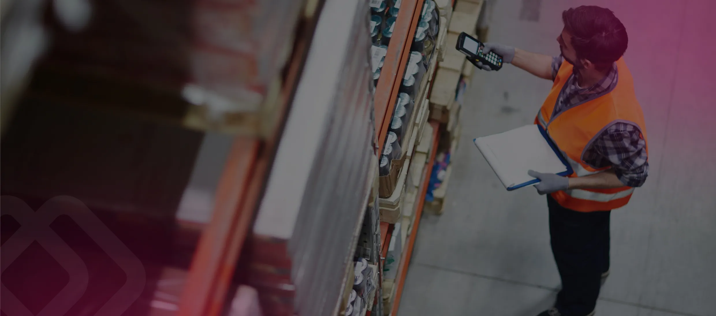 Worker with a clipboard by warehouse shelves