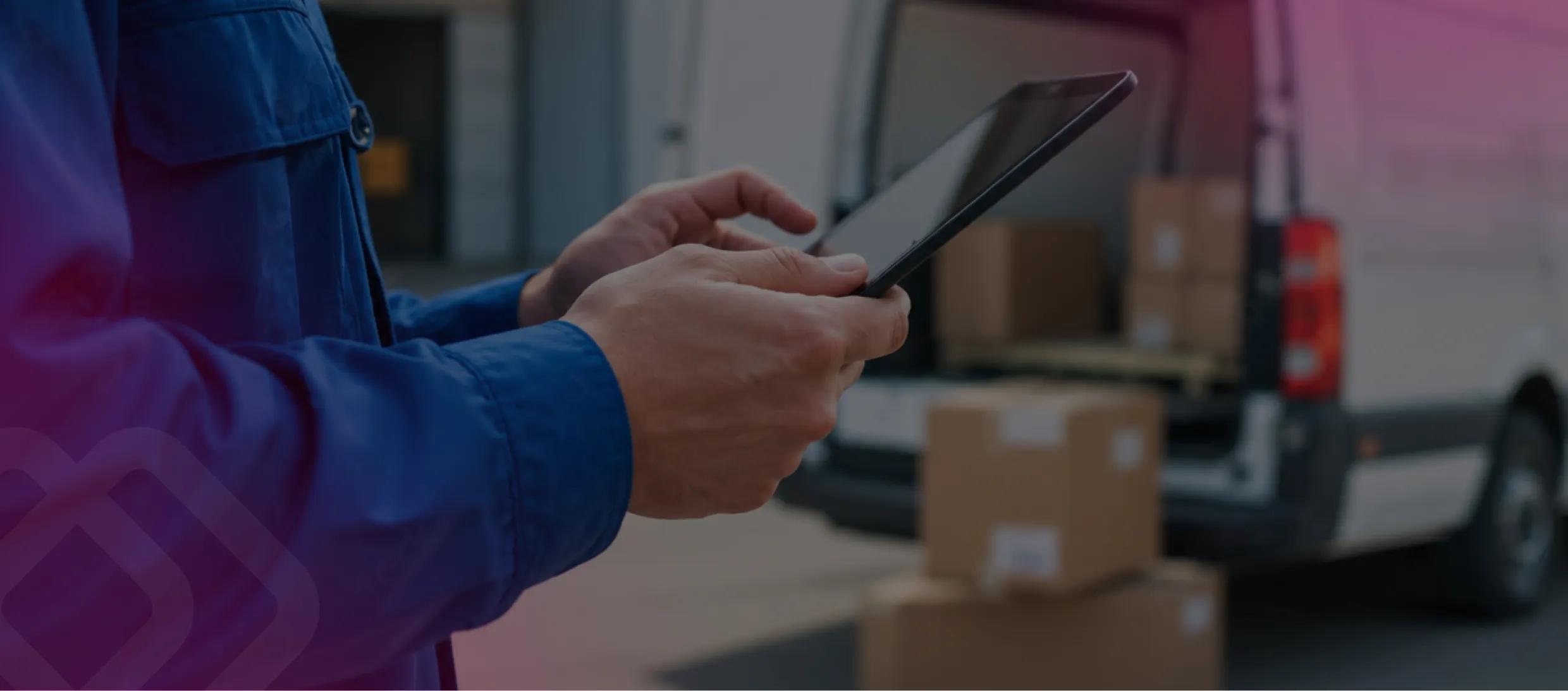 Worker using a tablet by a delivery van