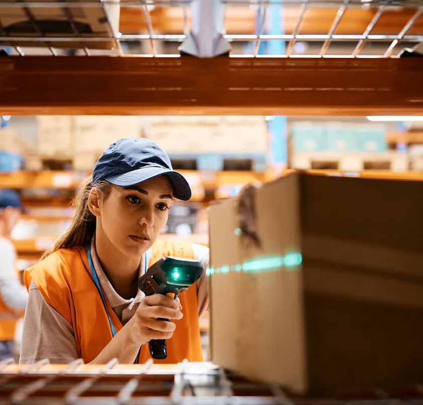 Worker scanning a box with a barcode scanner