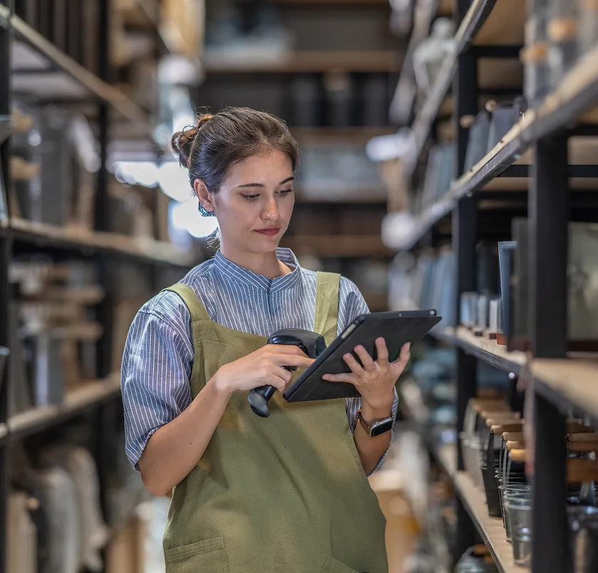Worker using a tablet in a warehouse aisle