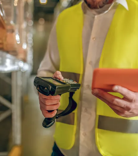Worker holding a barcode scanner and tablet